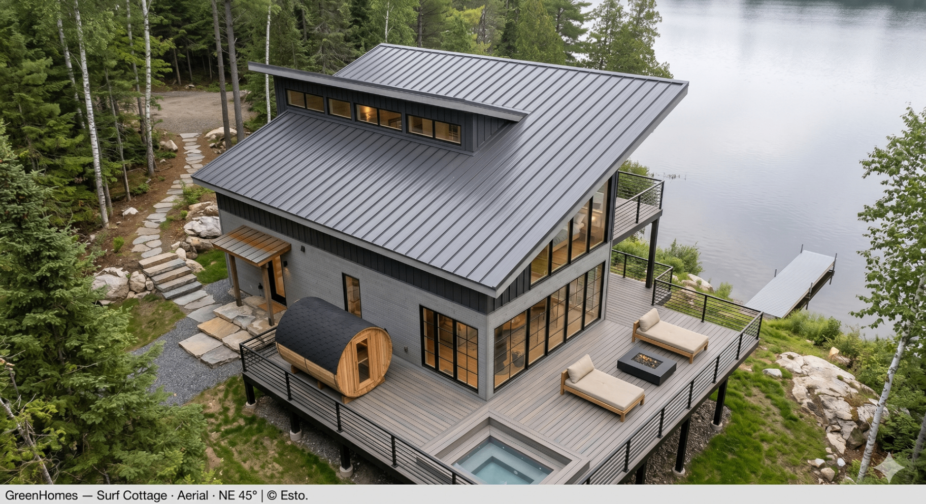 Surf Cottage — aerial NE 45° showing the monopitch charcoal metal roof, wrap deck, barrel sauna and sunken hot tub above a still Muskoka lake.